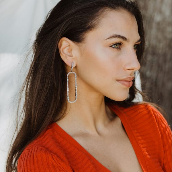 model in red dress wearing diamond rectangle earrings