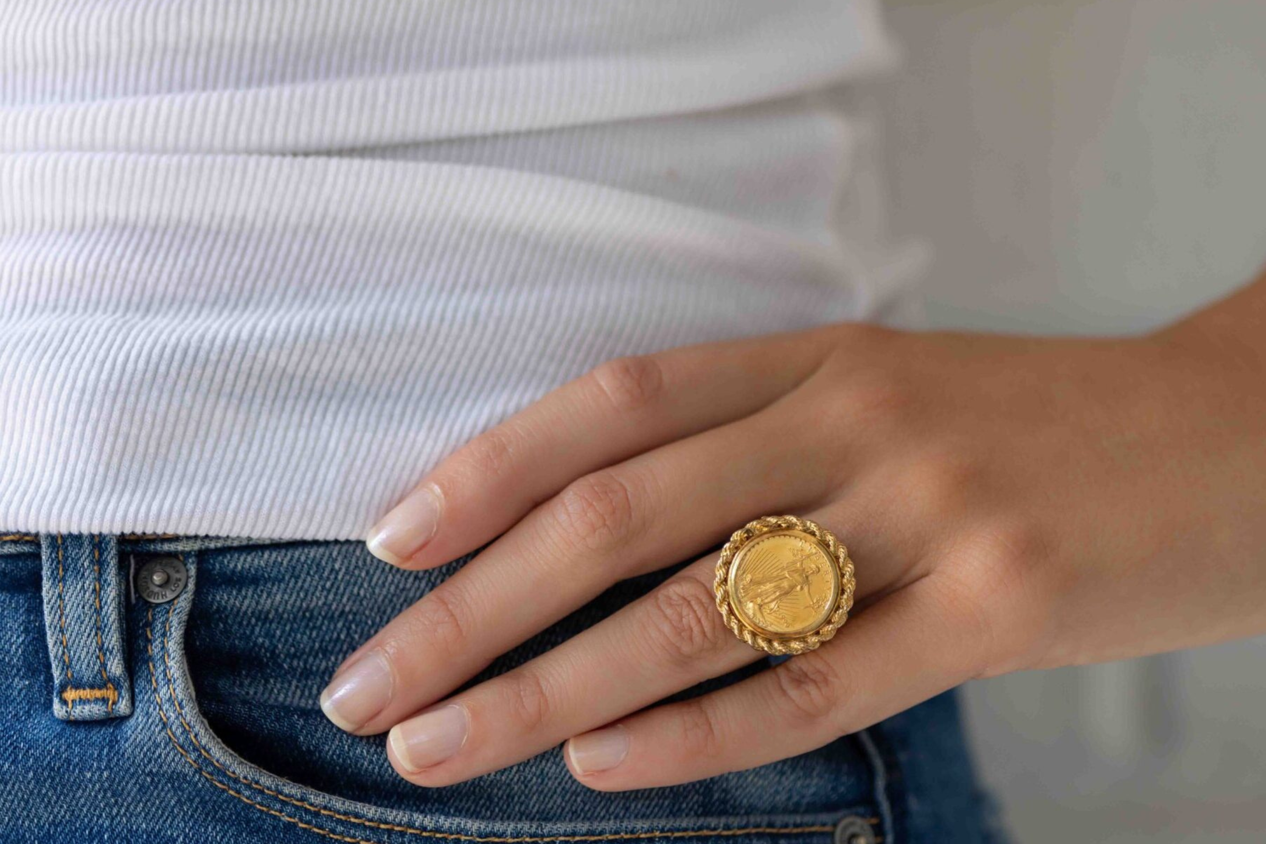 woman modeling vintage coin ring